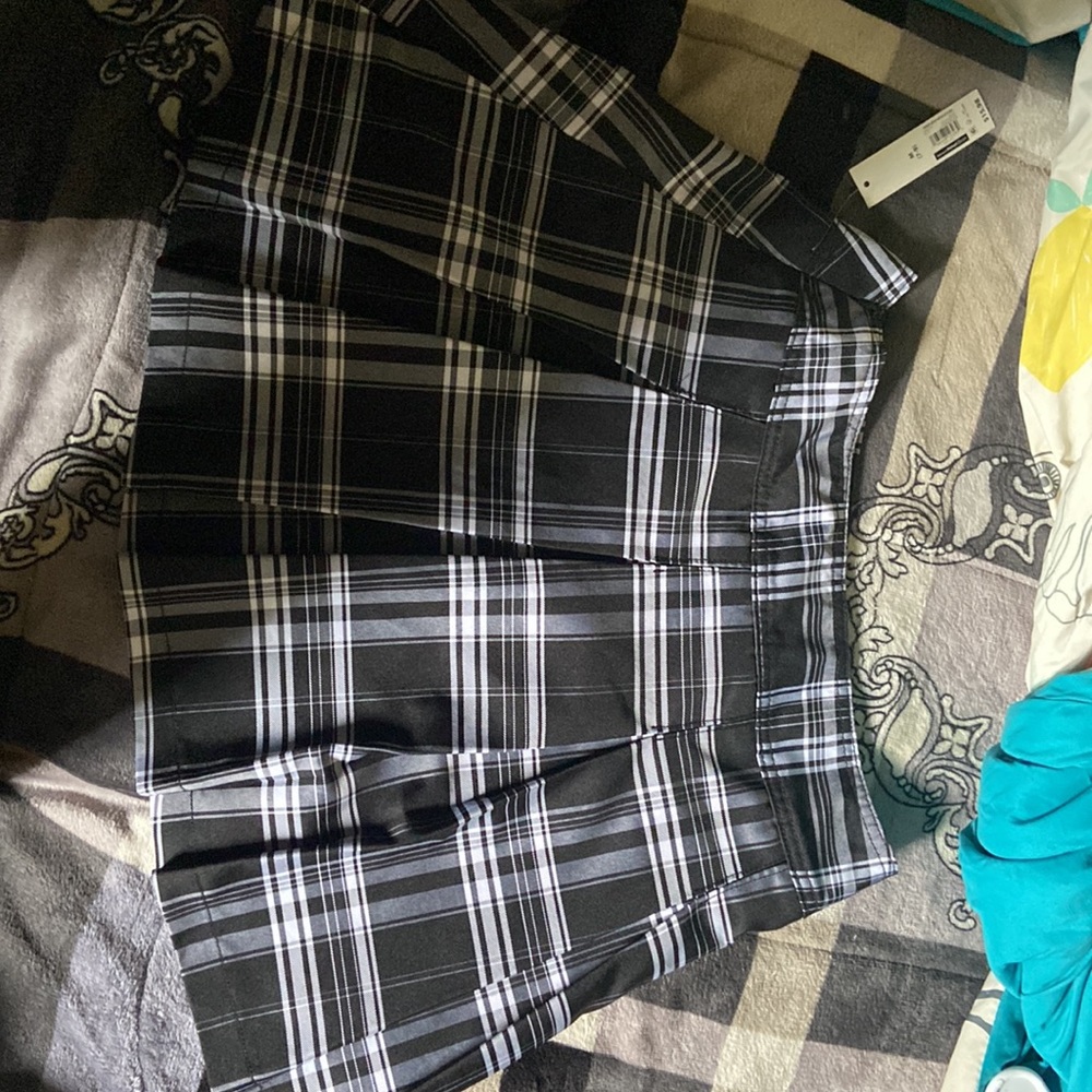It’s a black and white skirt with red,black,white, and gold patches - Picture 2 of 2